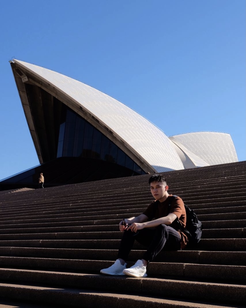 a guy sitting on a stair