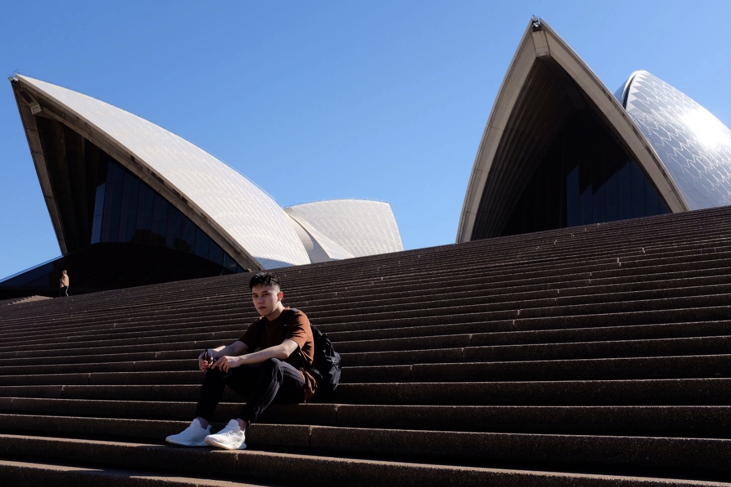 a guy sitting on a stair